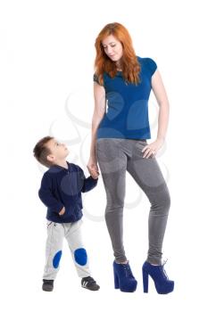 Young redhead woman posing with a nice little boy. Isolated on white