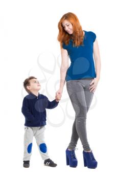 Pretty smiling woman posing with a little boy. Isolated on white