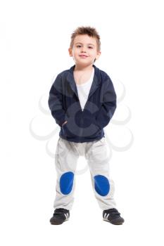 Handsome little boy posing in sport clothes. Isolated on white