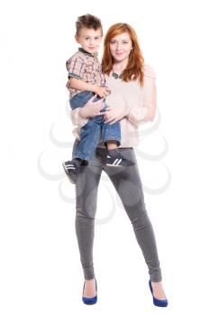 Redhead woman posing with a little boy on her hands. Isolated