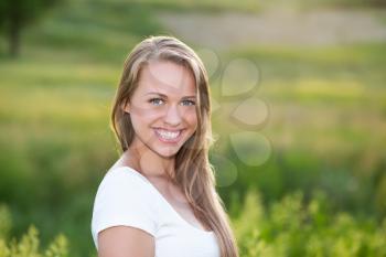 Portrait of joyful young woman posing outdoors