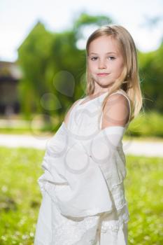 Portrait of nice little girl wearing white dress