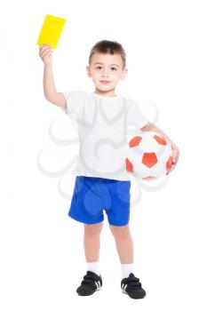 Nice little boy shows a yellow card. Isolated on white
