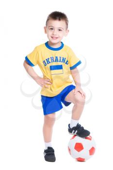 Nice little Ukrainian footballer posing with a ball. Isolated on white