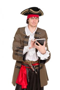Smiling young man in pirate costume posing with a tablet. Isolated on white