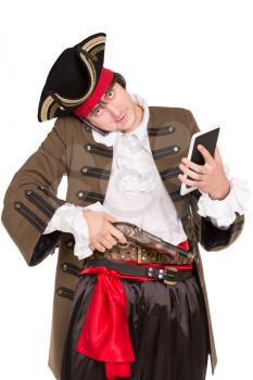 Young man in pirate costume posing with a tablet, mobile phone and pistol. Isolated on white