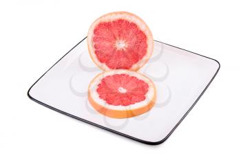 Grapefruit in square plate. Isolated on white