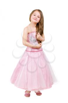 Cheerful little girl in pink dress touching her hair. Isolated on white