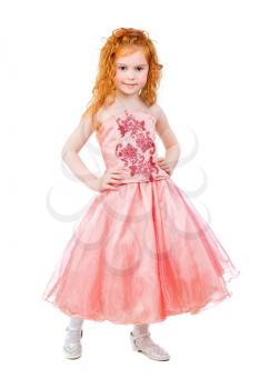 Cute little redhead girl posing in nice pink dress. Isolated on white