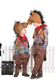 Two boys wearing horse costumes. Isolated on white