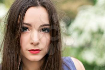 Portrait of young brunette with big alluring eyes