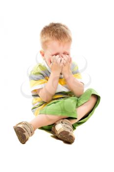 Little blond boy in shorts and t-shirt crying. Isolated on white
