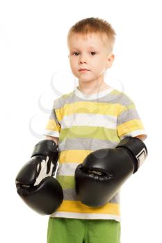 Little funny boy posing with the boxing gloves. Isolated on white
