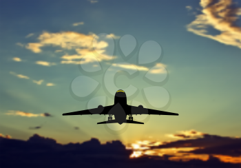 Passenger jet airplane silhouette in blurred sunset sky. Vector illustration. 