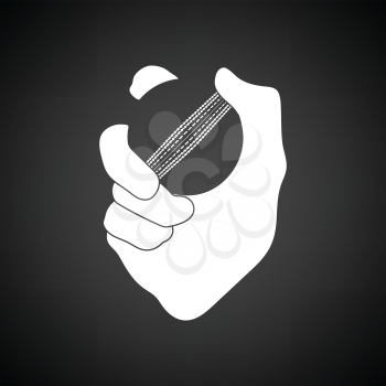 Hand holding cricket ball icon. Black background with white. Vector illustration.