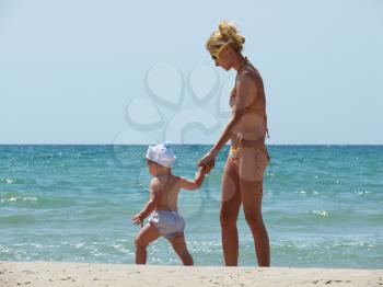 Royalty Free Photo of a Woman and Little Kid on the Beach
