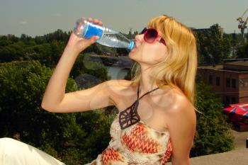 Royalty Free Photo of a Woman Drinking a Bottle of Water