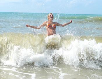 Royalty Free Photo of a Woman Running Through Waves