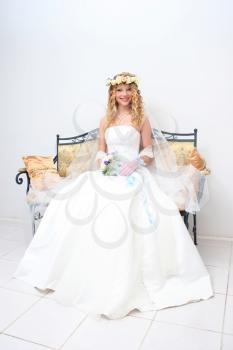 Royalty Free Photo of a Bride Sitting on a Bench