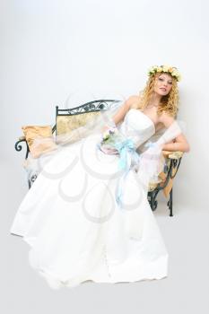 Royalty Free Photo of a Bride Sitting on a Bench