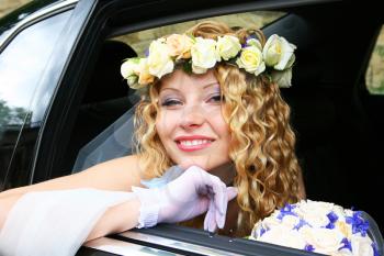 Royalty Free Photo of a Bride Sitting in a Vehicle