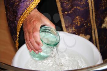 Royalty Free Photo of a Priest Pouring Water