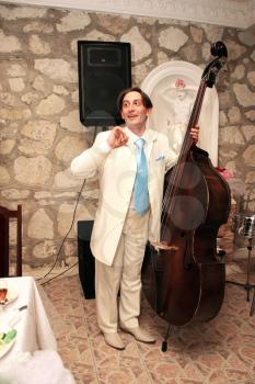 Royalty Free Photo of a Groom Playing the Upright Bass