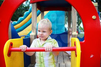 Royalty Free Photo of a Little Boy Playing at a Playground