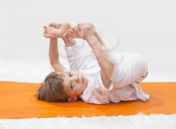 Royalty Free Photo of a Little Boy Doing Yoga