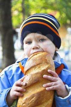 Royalty Free Photo of a Little Boy Eating Bread