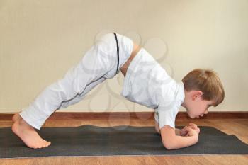 Royalty Free Photo of a Little Boy Practicing Yoga 