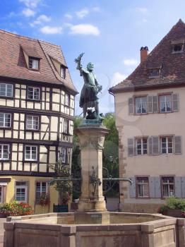Royalty Free Photo of a Statue and Fountain in Central Square of Colmar, France 