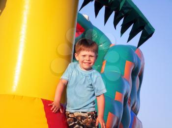 Royalty Free Photo of a Boy Playing on an Inflatable Castle
