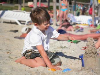 Royalty Free Photo of a Little Boy Playing at the Beach