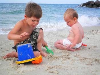 Royalty Free Photo of Two Little Boys Playing at the Beach 