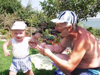 Grandfather and grandson in the garden