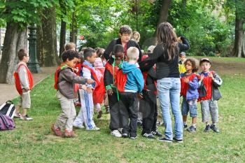PARIS, FRANCE - JULY 10: group of french unidentified kids with two teachers in the sity park on July 10, 2012 in Paris, France.