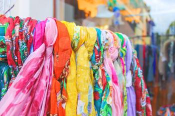 Souvenir scarves on a rack in outdoor sales