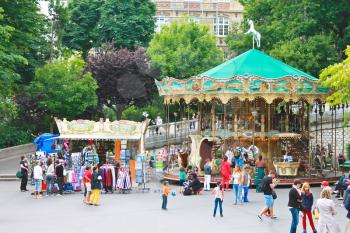 Parisians and tourists near the carousel on Montmartre. Paris.