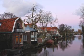 Christmas lights in houses on a river in Dutch town Loenen. . Netherlands