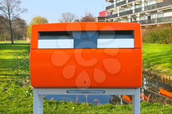 Dutch public orange mailbox on a city street. Netherlands