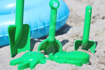 Children toys and swim ring on the sand beach