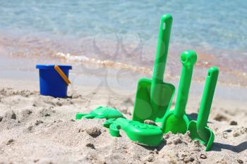 Children sand toys on the beach near the sea