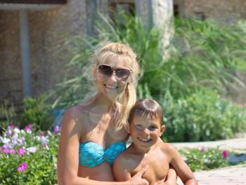 Happy mother and son in a spa hotel near pool