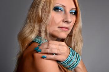 Royalty Free Photo of a Closeup of a Young Woman With Blue Jewellery