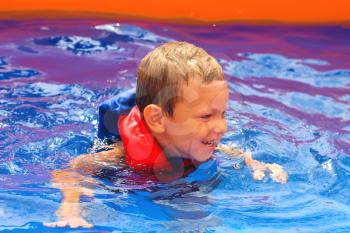 Royalty Free Photo of a Child in a Pool