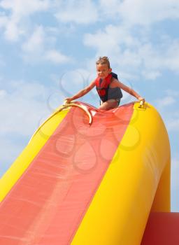 Enthusiastic kid on slide in the waterpark