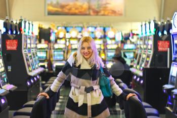 Happy girl near the slot machines at the airport in Las Vegas