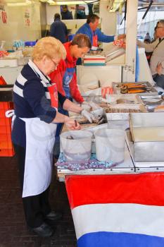 DORDRECHT, THE NETHERLANDS - SEPTEMBER 28: Workers cut up fish for sale at a market on September 28, 2013 in Dordrecht, Netherlands 