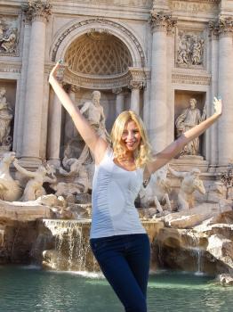 Roman Holiday. Happy girl on the background of the Trevi Fountain in Rome